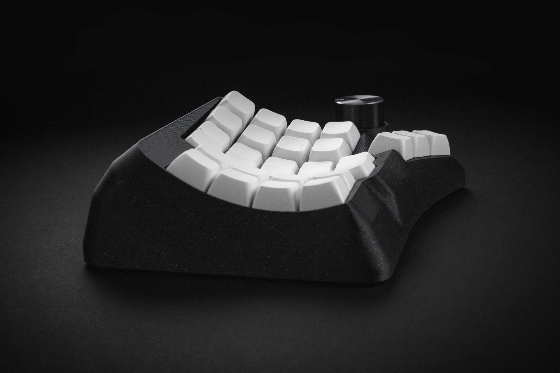 Low side view showing the curved profile of the Phenom case and key rows