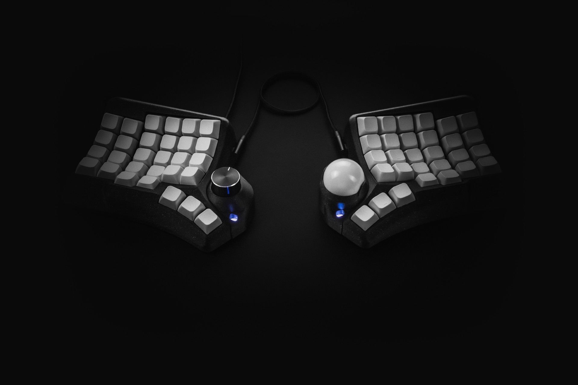 Phenom keyboard on a black background with encoder and trackball modules